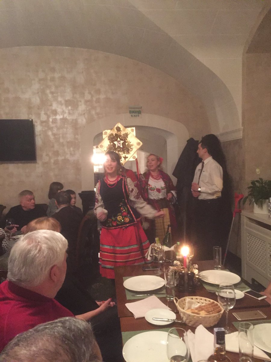 Singers in traditional dress traveling from public place to public place singing